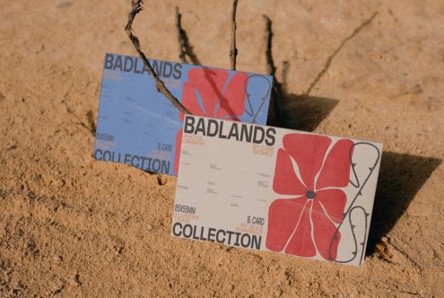 Two business cards with abstract design mockup placed on sandy background, showcasing graphic design and print layout.