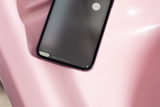 Smartphone mockup on pink surface, modern mobile design, blank screen for graphic display presentation, digital asset for designers.