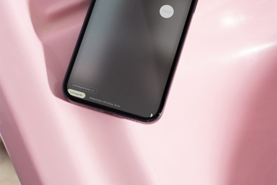 iPhone mockup on pink background showing focus app loading screen