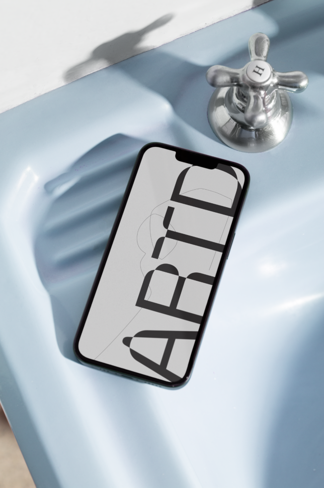 Smartphone on sink showcasing abstract font design, ideal for mockups category, displaying creative typography.