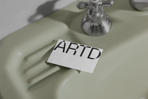 Elegant serif font design mockup on paper with shadow, placed on vintage green sink, showcasing typography, suitable for graphic assets.