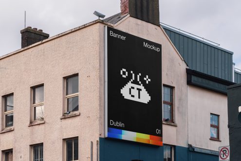 Black banner mockup with color gradient strip on Dublin residential building