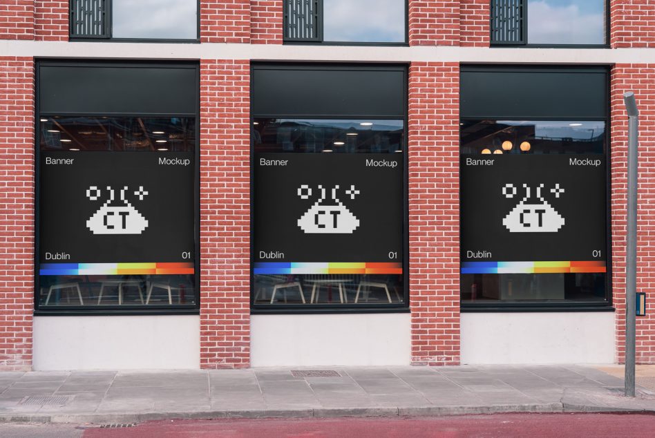 Row of three window banners with color test bars on brick storefront