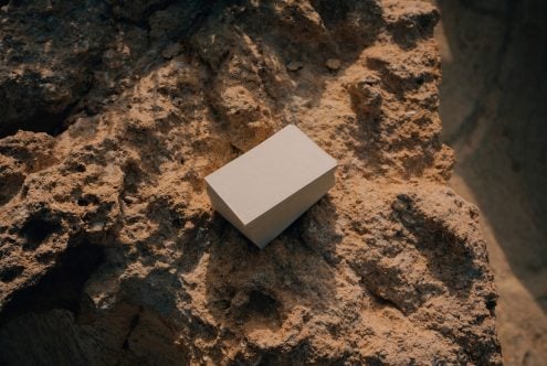 Plain business card stack sitting on rough stone surface
