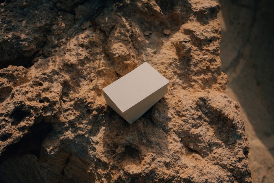 Plain business card stack sitting on rough stone surface