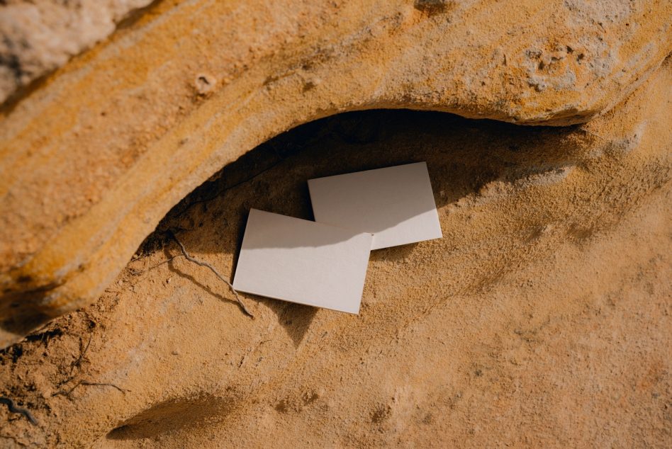 Blank business cards fanned out in carved rock niche outdoors