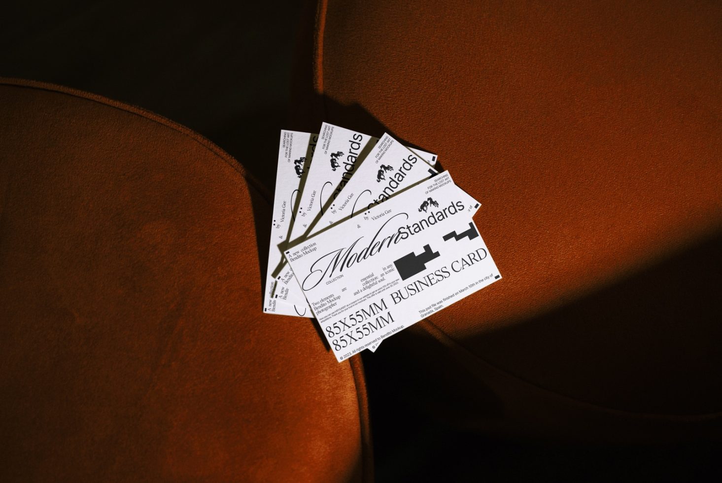 Stylish business card mockup on leather chair, elegant presentation for branding, design assets for graphic designers.