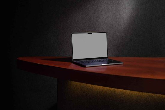 Elegant laptop mockup on wooden desk with ambient lighting, showcasing screen for template and design presentation.