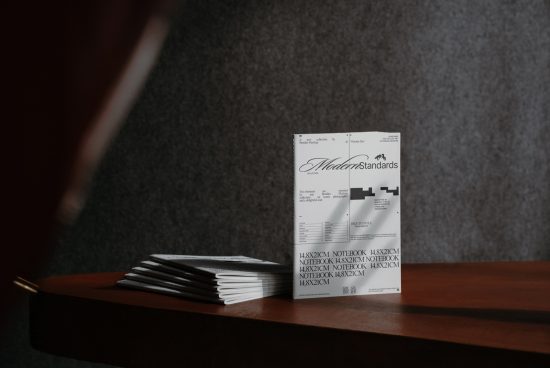 Professional stationery mockup featuring multiple notebooks with a sophisticated design on a wooden table. Ideal for showcasing templates and graphics.