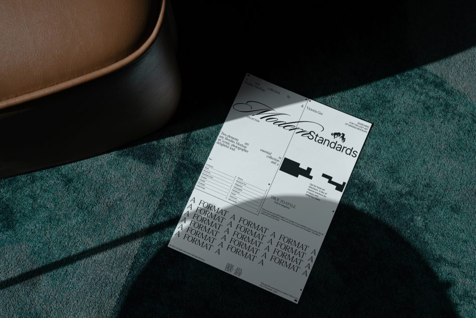 Print design template of a modern brochure lying on a teal carpet next to a brown leather chair, showcasing elegant typography and layout.