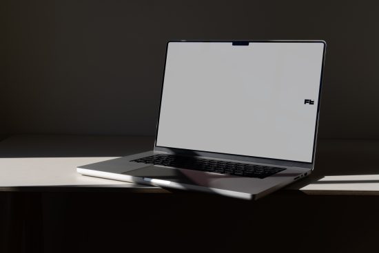 Open laptop on desk with sunlight, minimalist design mockup, modern computer template for UI/UX presentation, digital asset for designers.