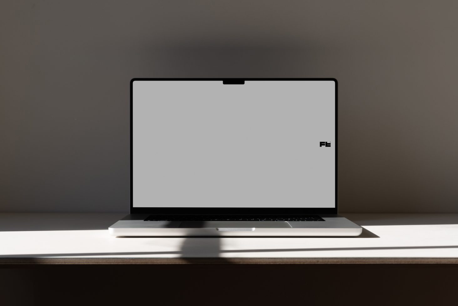 Minimalist laptop mockup on desk with clean background, ideal for website design presentations, digital portfolio display, and tech-related graphic showcases.