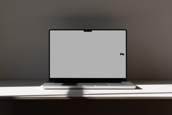 Minimalist laptop mockup on desk with clean background, ideal for website design presentations, digital portfolio display, and tech-related graphic showcases.