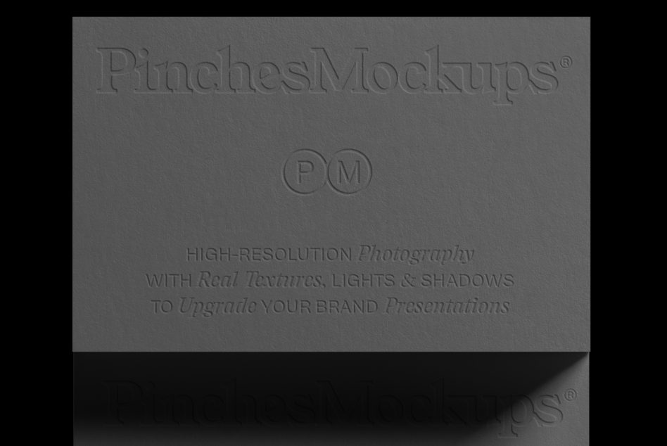Gray business card flat lay showing embossed logo in center of frame
