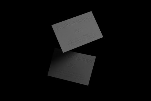 Two gray business cards arranged at angles on dark background