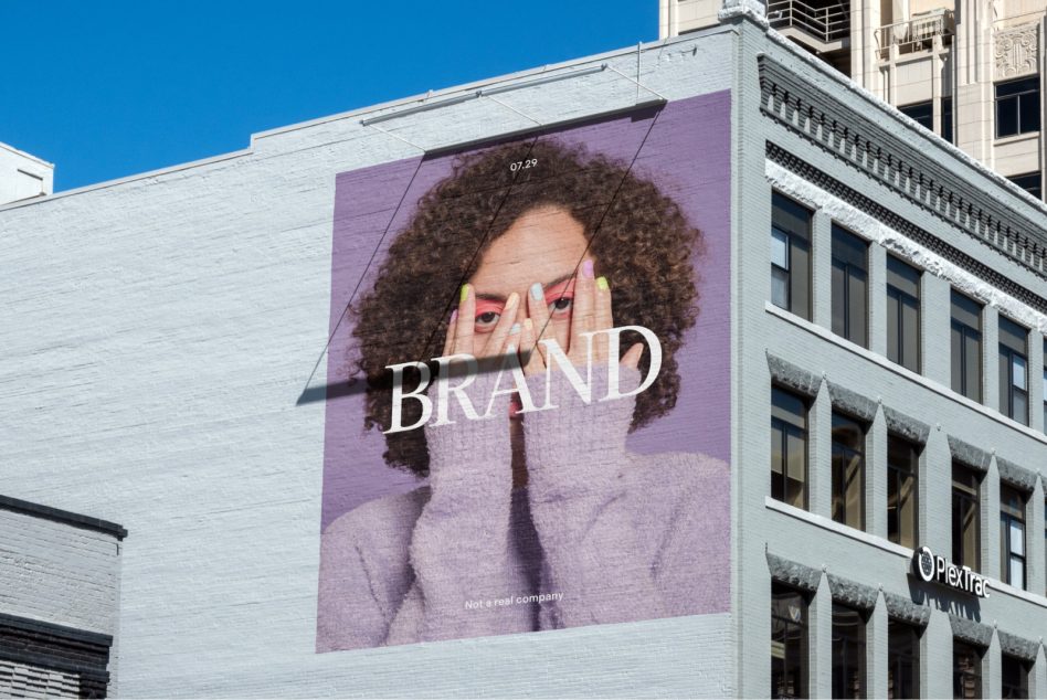 Urban billboard mockup featuring a woman peering through fingers, ad design template, cityscape background, for designers.