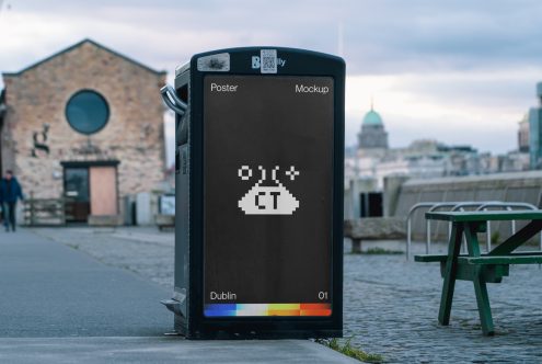 Black digital poster on Dublin street showing pixelated UFO logo against waterfront backdrop