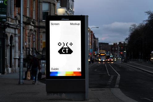 White JCDecaux billboard with black pixel UFO, color spectrum bar below