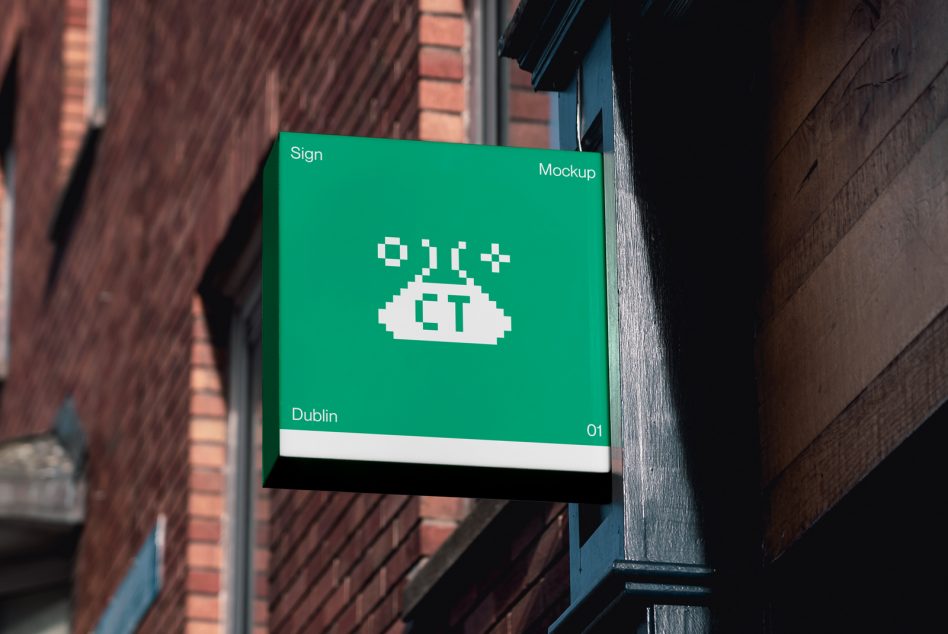 Bright green hanging sign on alley wall between brick buildings