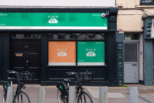 Storefront with green signage displaying pixel art logo on Dublin street