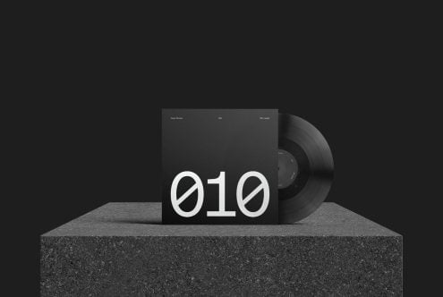 Vinyl record and album cover mockup on textured background, minimalist design for music and branding presentation.