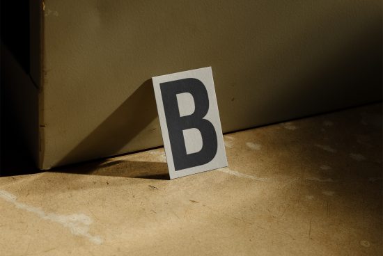 Elegant serif letter B card mockup with a dramatic shadow, showcasing font design and presentation, ideal for graphic assets.