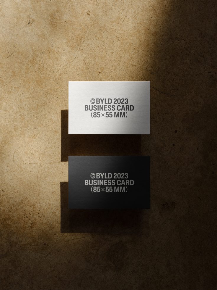 Elegant black and white business card mockup on textured background, showcasing front and back design, ideal for presentations and branding.