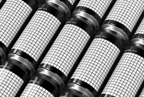 Black and white photo of multiple camera lenses aligned with a grid pattern on barrel surfaces, ideal for mockup references in design.