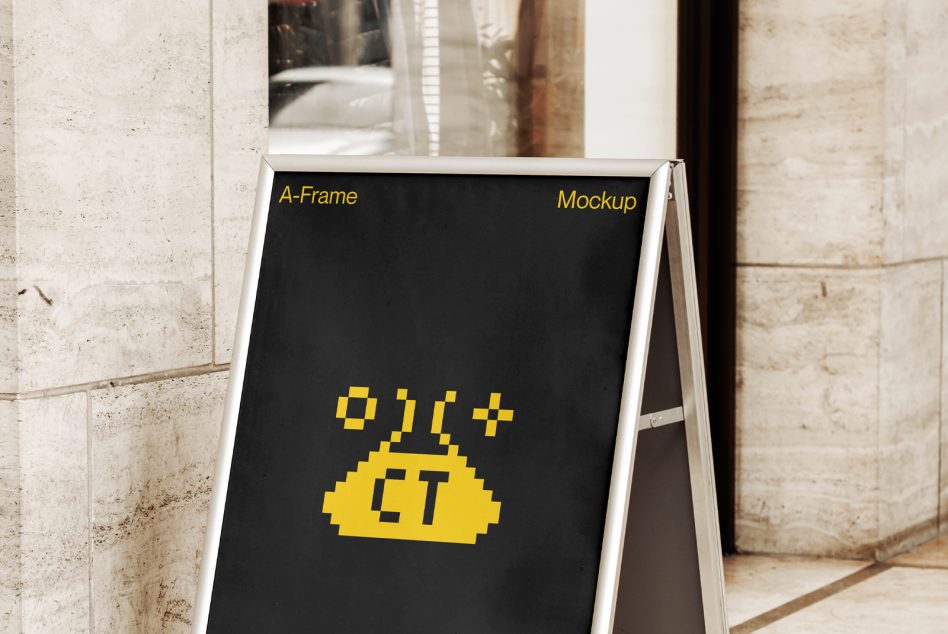 Black A-Frame with yellow pixel art ET character on concrete