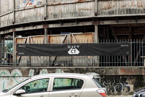 Dark horizontal banner on weathered industrial warehouse building mockup