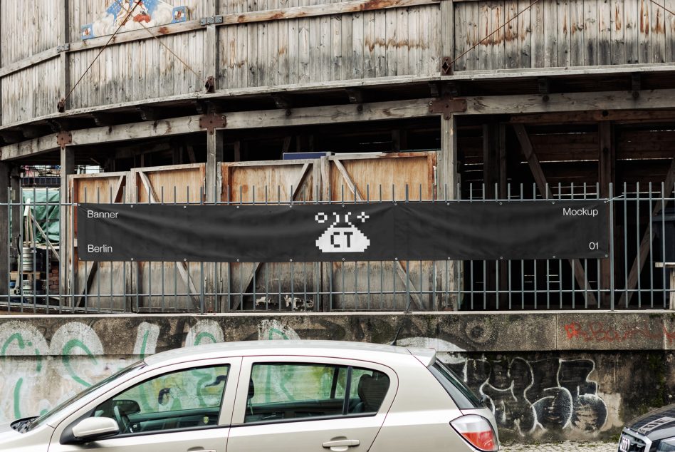 Dark horizontal banner on weathered industrial warehouse building mockup