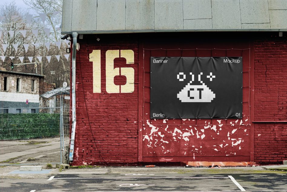 Black fabric banner on red industrial building with pixel UFO design mockup