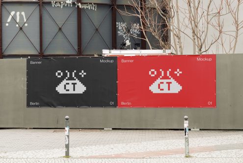 Outdoor street banners on brick wall showing pixel art UFO design in red black
