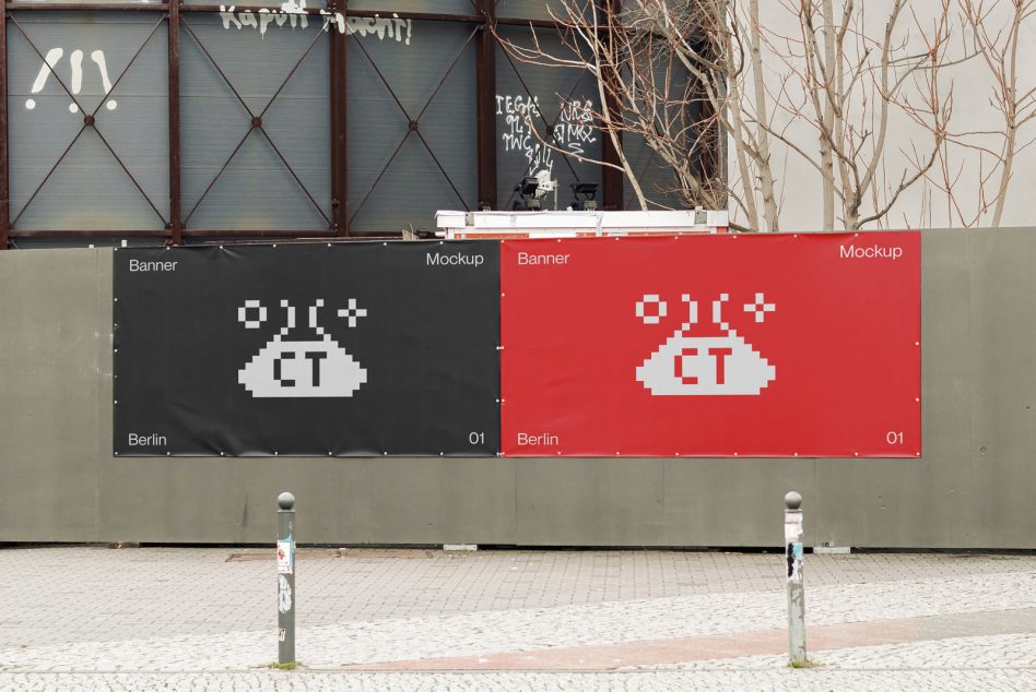 Outdoor street banners on brick wall showing pixel art UFO design in red black