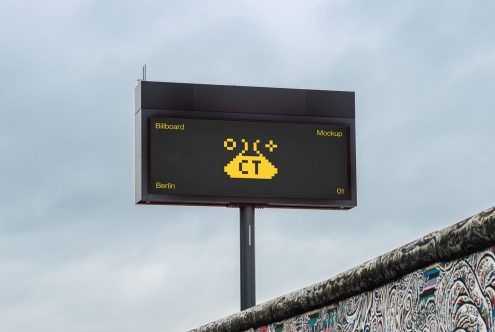 Horizontal dark billboard with glowing yellow pixel alien graphic centered