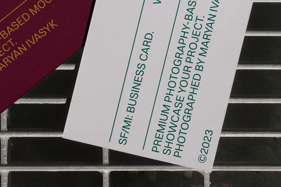 Maroon card next to white business card on concrete steps with shadows