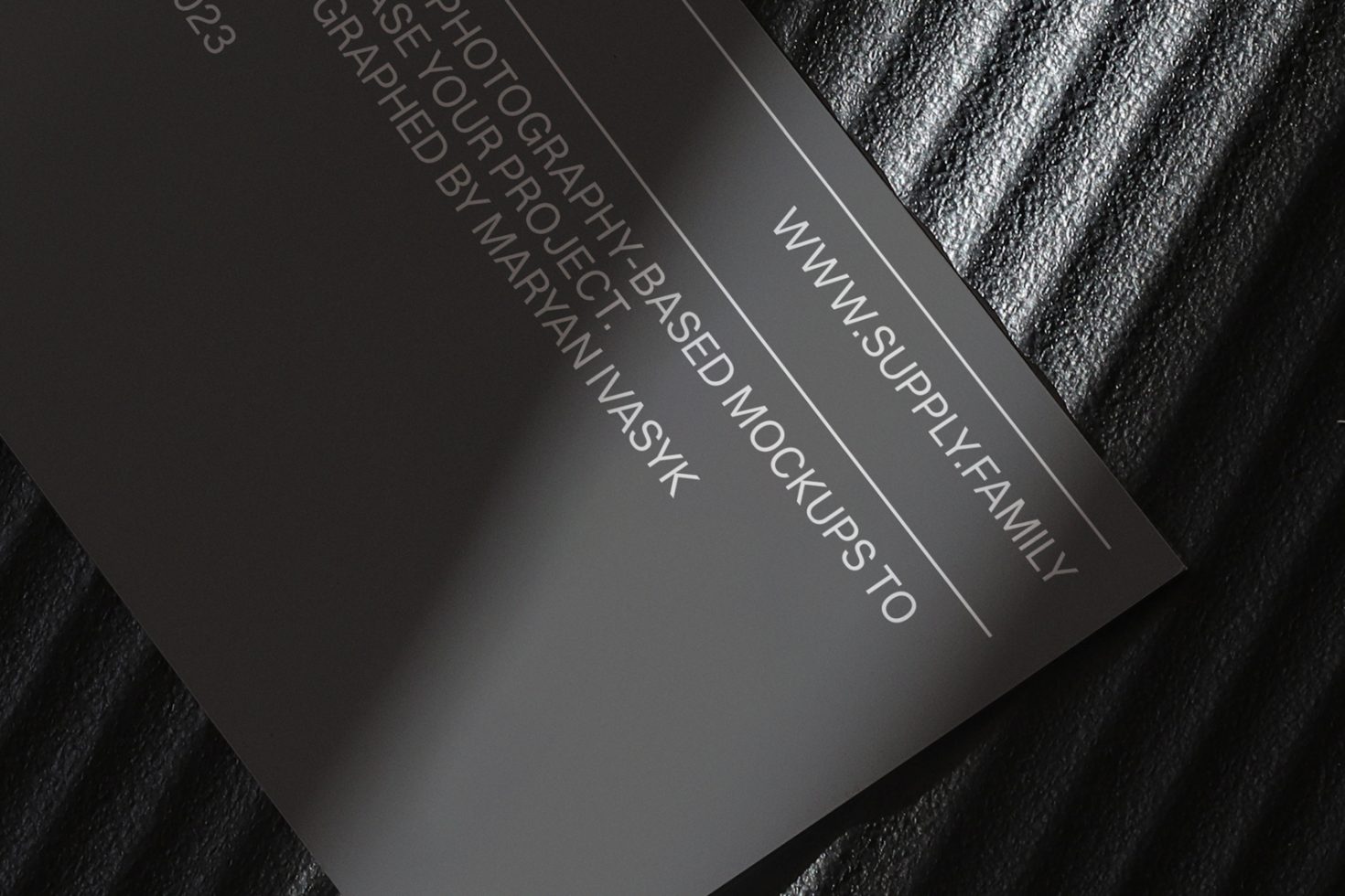 Elegant business card mockup with reflective black surface for graphic design presentations, showcasing sleek typography and branding details.