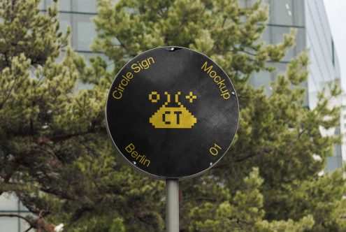 Dark circular sign pole with yellow pixel alien graphic, Berlin location tag visible