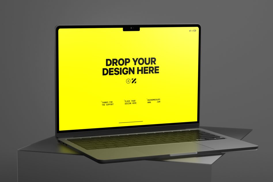 Open laptop showing bright yellow screen with drop design template