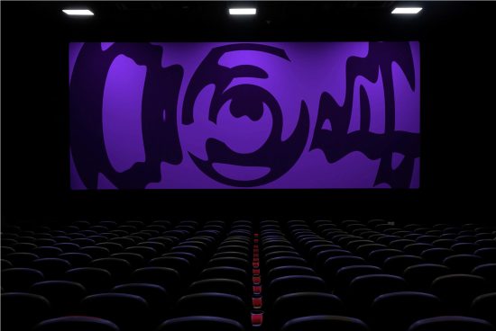 Cinema theater interior mockup with rows of black seats and a large screen displaying a purple abstract graphic design.