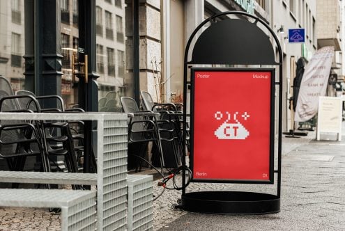 Rounded poster stand on Berlin street displaying red background with white pixel art cloud