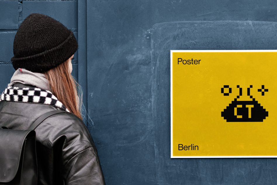 Woman viewing yellow pixel art UFO poster on blue metal wall