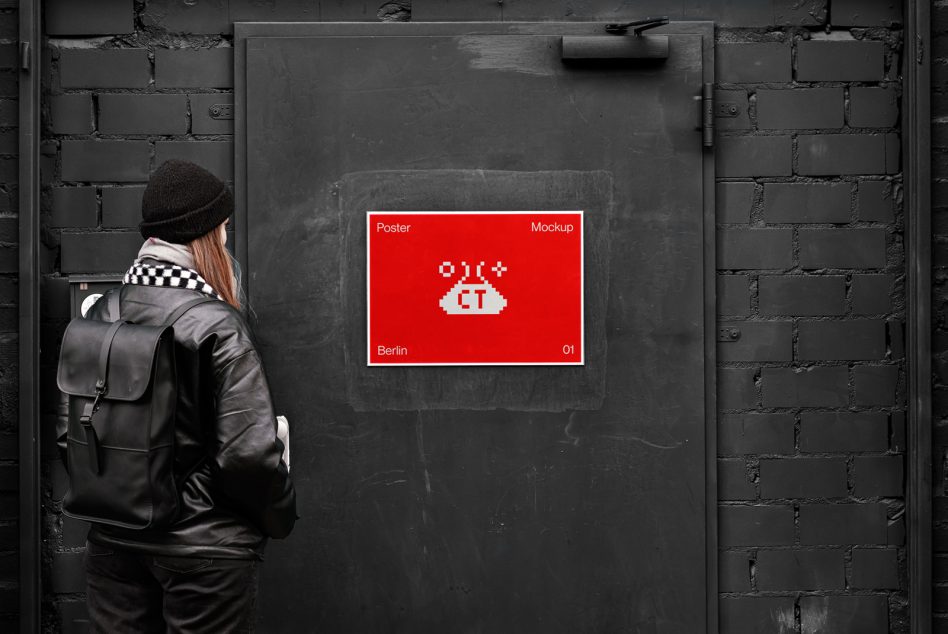 Person viewing red pixel UFO poster mockup on dark brick wall