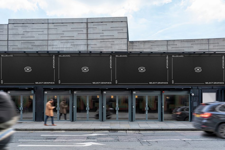 Row of dark storefronts with black billboards above, numbered units, motion blur street scene