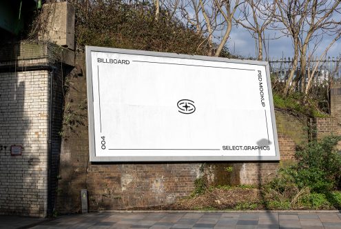 Outdoor billboard mockup on a brick wall with clear sky, ideal for realistic design presentations in urban settings, perfect for graphic designers.