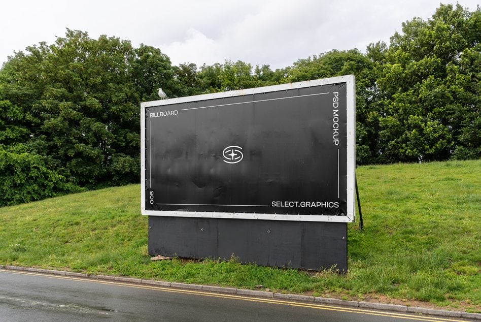 Dark billboard mockup in green field with white frame border showing sample layout