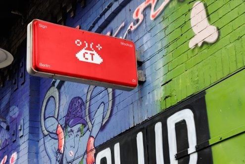 Red glowing sign with white pixelated taco over street art backdrop