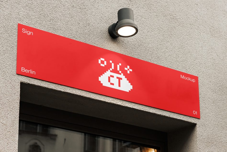 Red angled sign with white pixel logo mounted on concrete wall