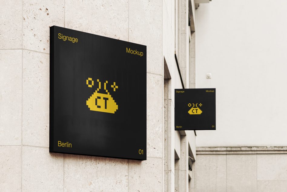 Large black signage with yellow pixelated logo next to smaller matching sign on wall