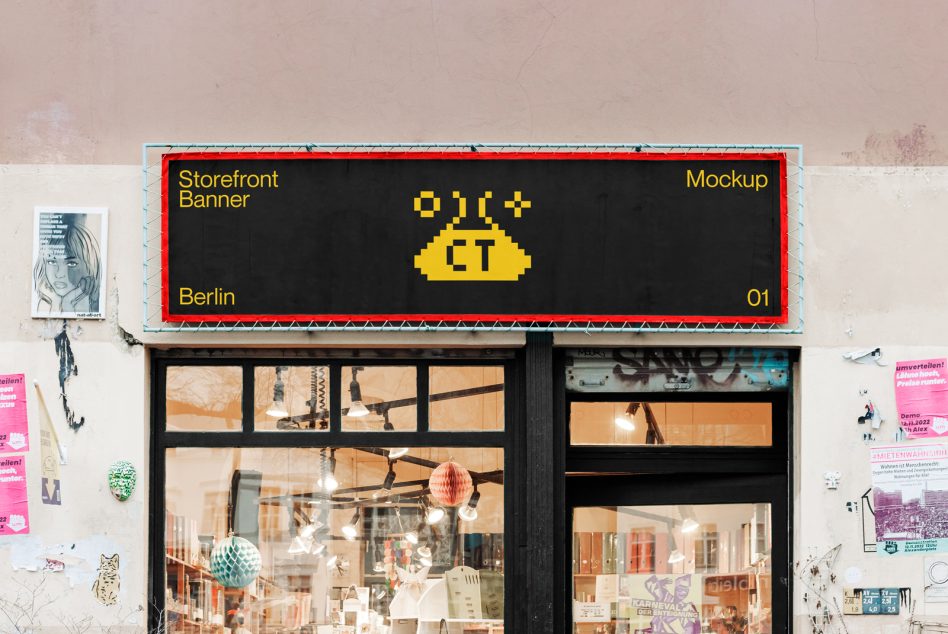 Black storefront banner with yellow type on shop window display